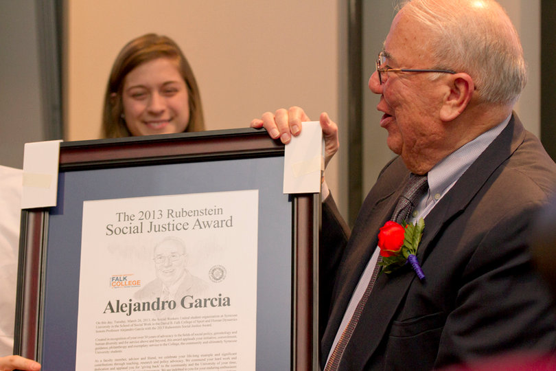 Alejandro Garcia, a professor of social work at Syracuse University, accepts the Daniel and Mary Lou Rubenstein Social Justice Award on Tuesday. Garcia has lead a life of altruism since he was young and his peers thought he was a perfect candidate.
