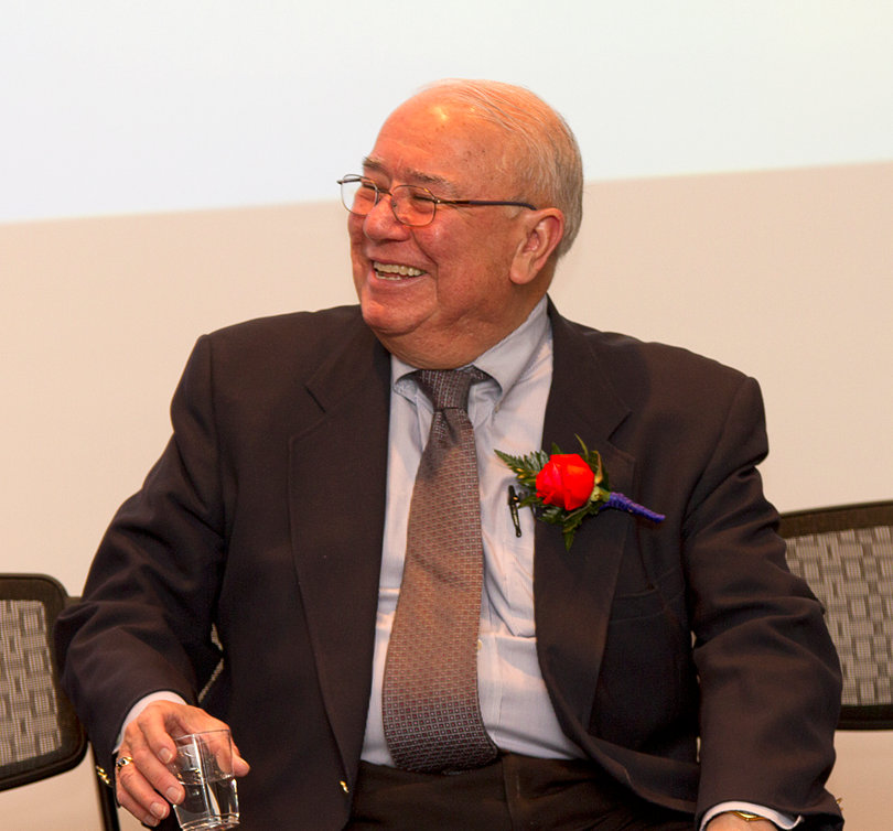 Alejandro Garcia, a Syracuse University professor of 35 years, smiles widely as he receives an award recognizing all of the work he has done for the Syracuse community.