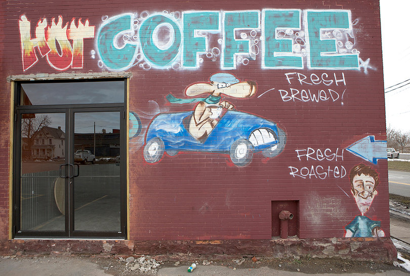 The outside of The Kind Coffee Company is decorated with graffiti to make the brick building stand out.