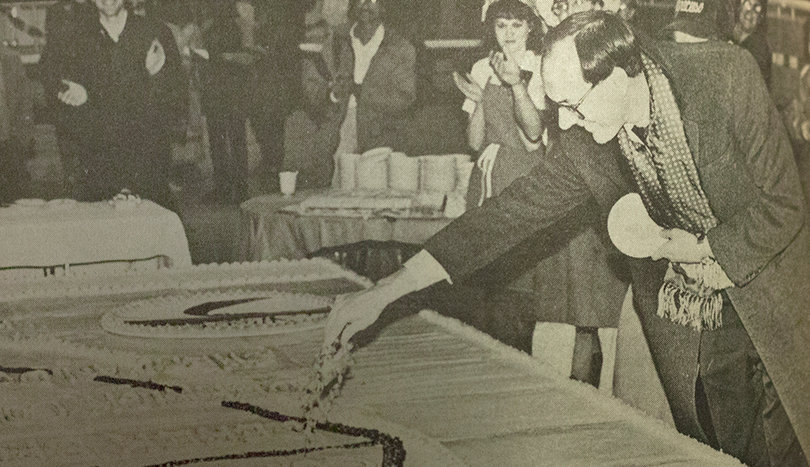 Jim Boeheim cuts a cake at a celebration of the 1987 Orangemen's national runner-up finish in Schine Student Center. The 17.5-foot square cake donated by Wegman's contained 130 smaller cakes and could feed 34,000 people.