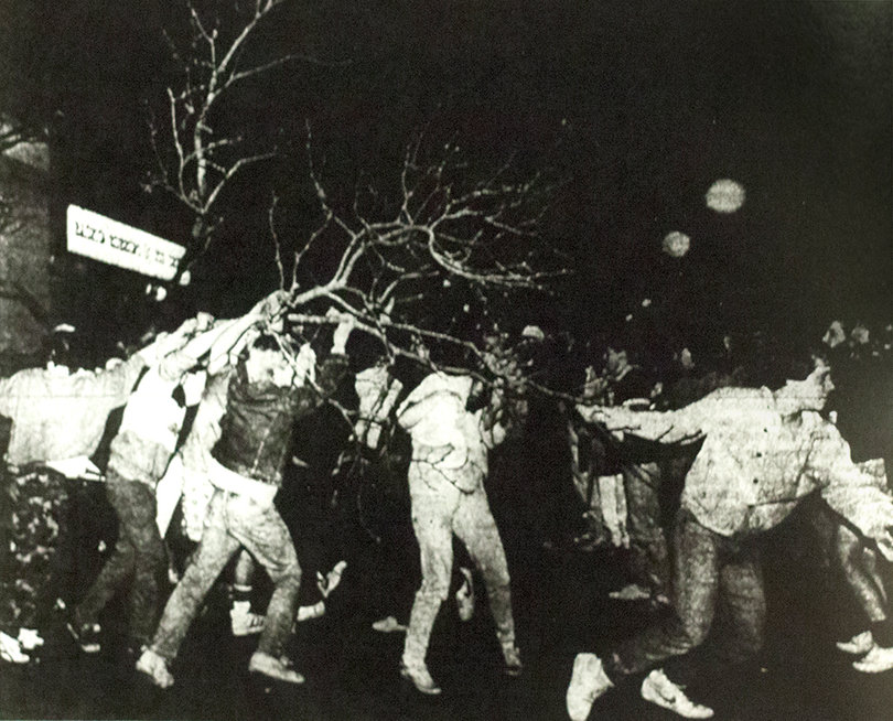 A group of people hauls a tree 50 yards from the corner of Marshall Street and South Crouse Avenue to the front of Buggsy's Bar following Syracuse's loss to Indiana in the 1987 national championship game.