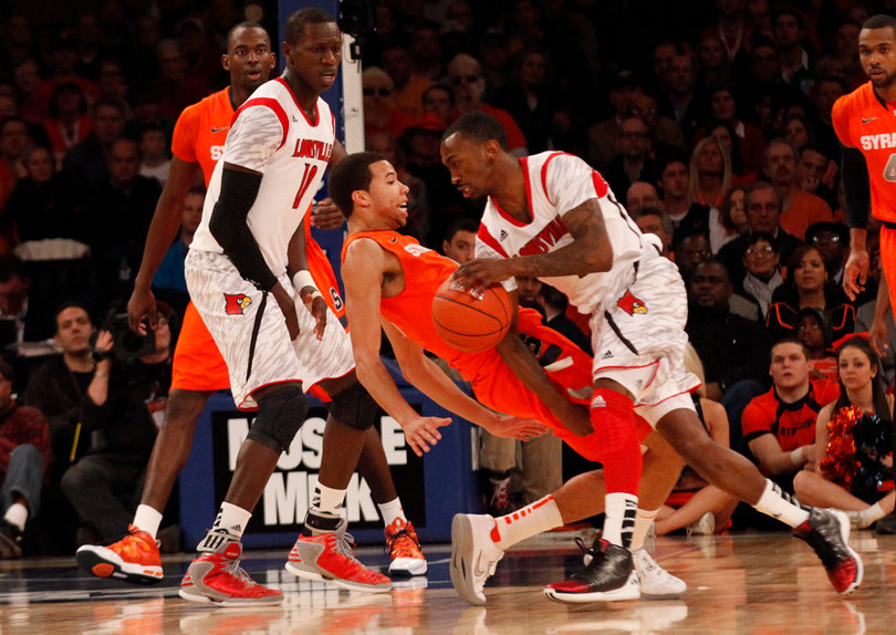 Louisville's Russ Smith (#2) knocks over Michael Carter-Williams while defending.