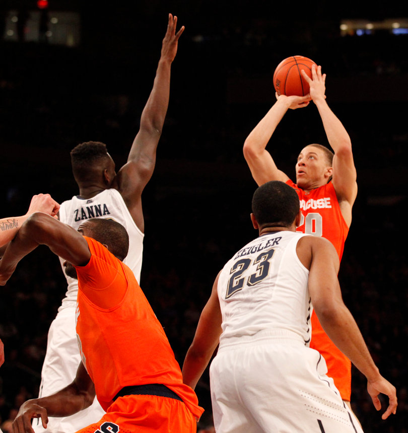 Brandon Triche shoots over Talib Zanna in Syracuse's 62-59 victory over Pittsburgh in the quarterfinals of the Big East tournament Thursday afternoon in Madison Square Garden. He and James Southerland combined for 32 points, 24 from 3s.
