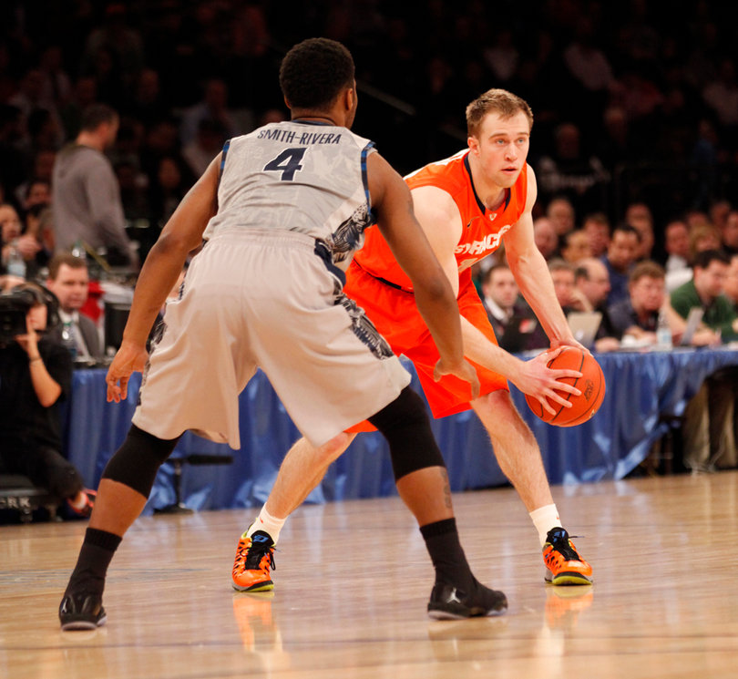 Trevor Cooney holds the ball at the point. He led the Orange in scoring in the first half.