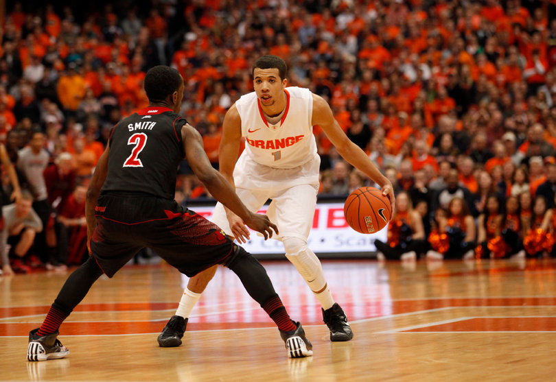 Michael Carter-Williams runs the Syracuse offense from the point against Russ Smith. 