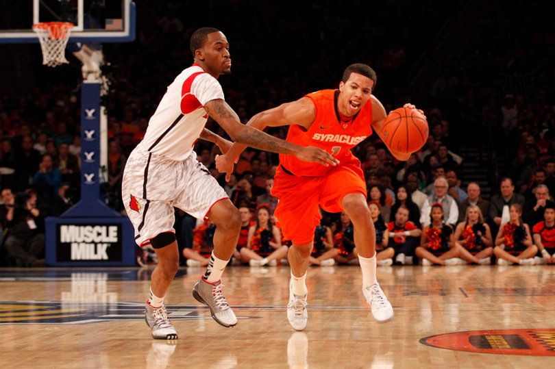 Michael Carter-Williams drives left through Louisville's pressure.