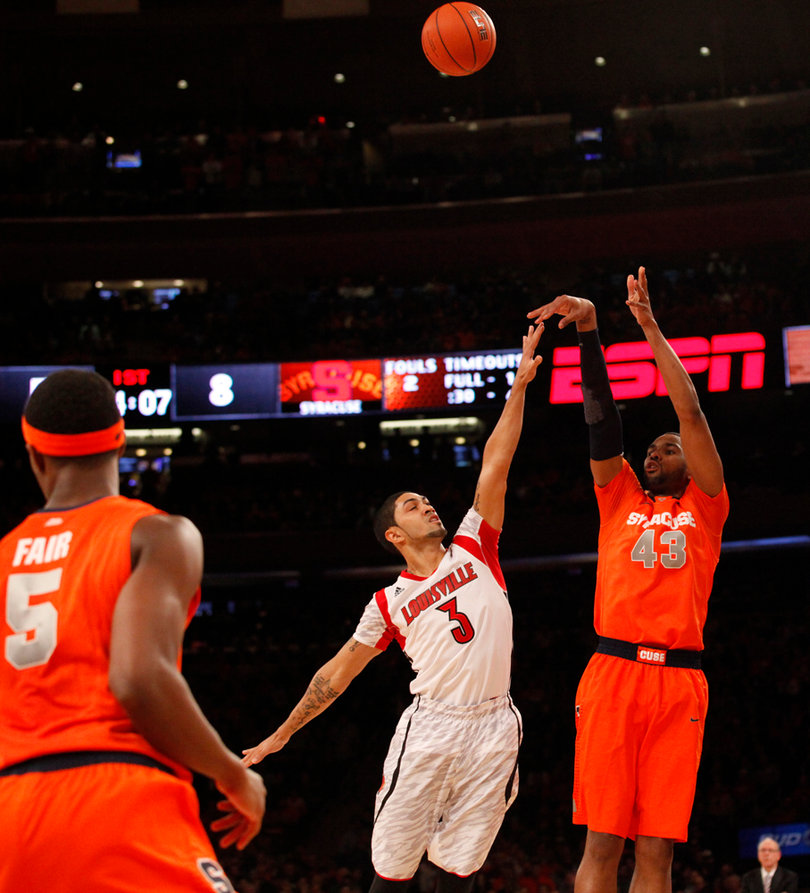 James Southerland shoots a 3 over Peyton Siva. He broke Gerry McNamara's record for 3s in a Big East tournament.