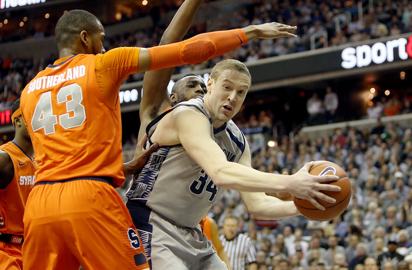 Nate Lubick (34) of the Georgetown Hoyas drives to the basket against James Southerland (43) and Rakeem Christmas.