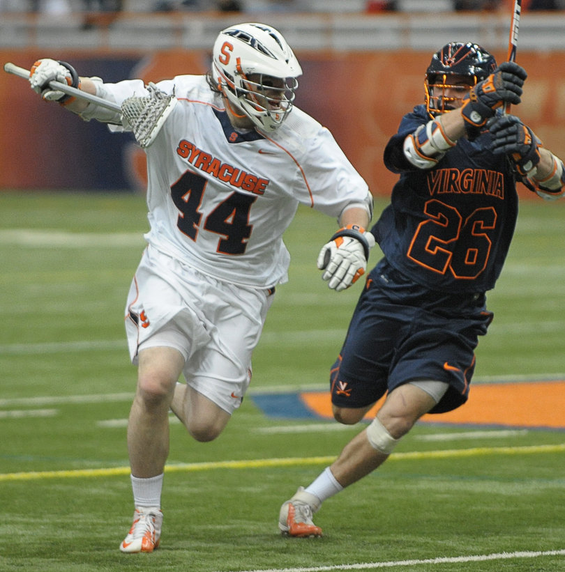 Syracuse defender Matt Harris pursues Virginia midfielder Mick Parks.