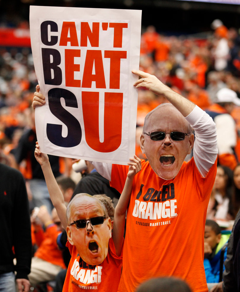 Syracuse fans look to draw the attention of CBS cameras just before tipoff against No. 12 Louisville in the Carrier Dome.