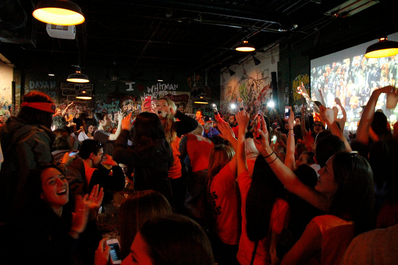 Syracuse University fans celebrate inside Chuck's Cafe, Saturday late afternoon after Syracuse defeated Marquette in the Elite 8. Syracuse will be heading to the Final Four for the first time in a decade.