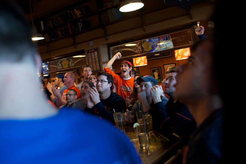John Jargin, a senior math education major, cheers inside Faegan's Pub during the Syracuse vs. Marquette matchup.