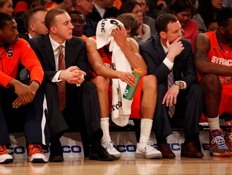 Michael Carter-Williams cools off while watching the game from the bench.