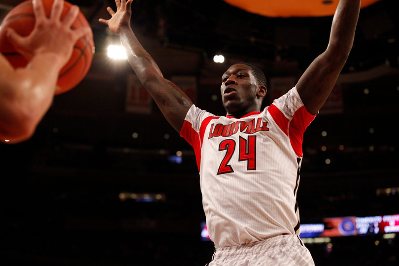 Louisville's Montrezl Harrell (#24) defends against Triche in the paint.