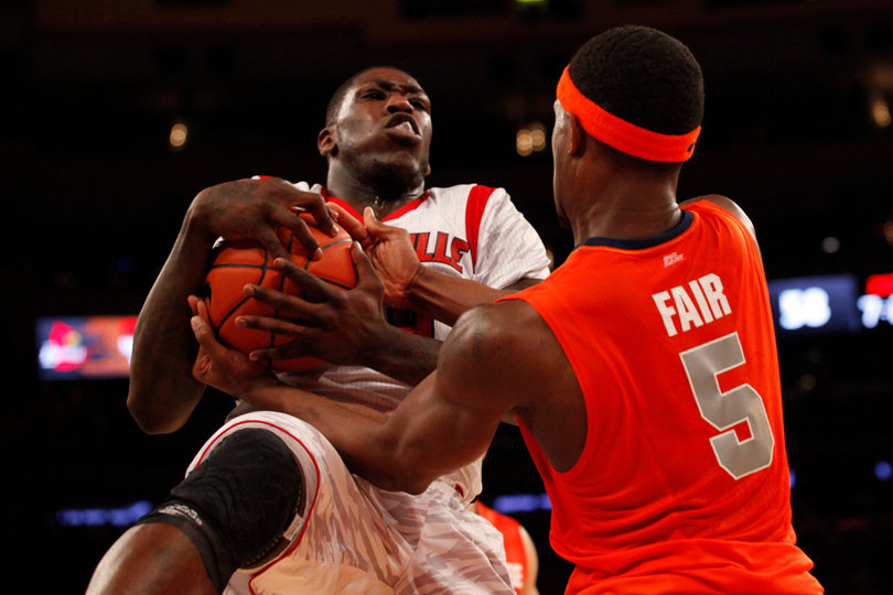 Louisville's Montrezl Harrell (#24) secures an offensive rebound against C.J. Fair.