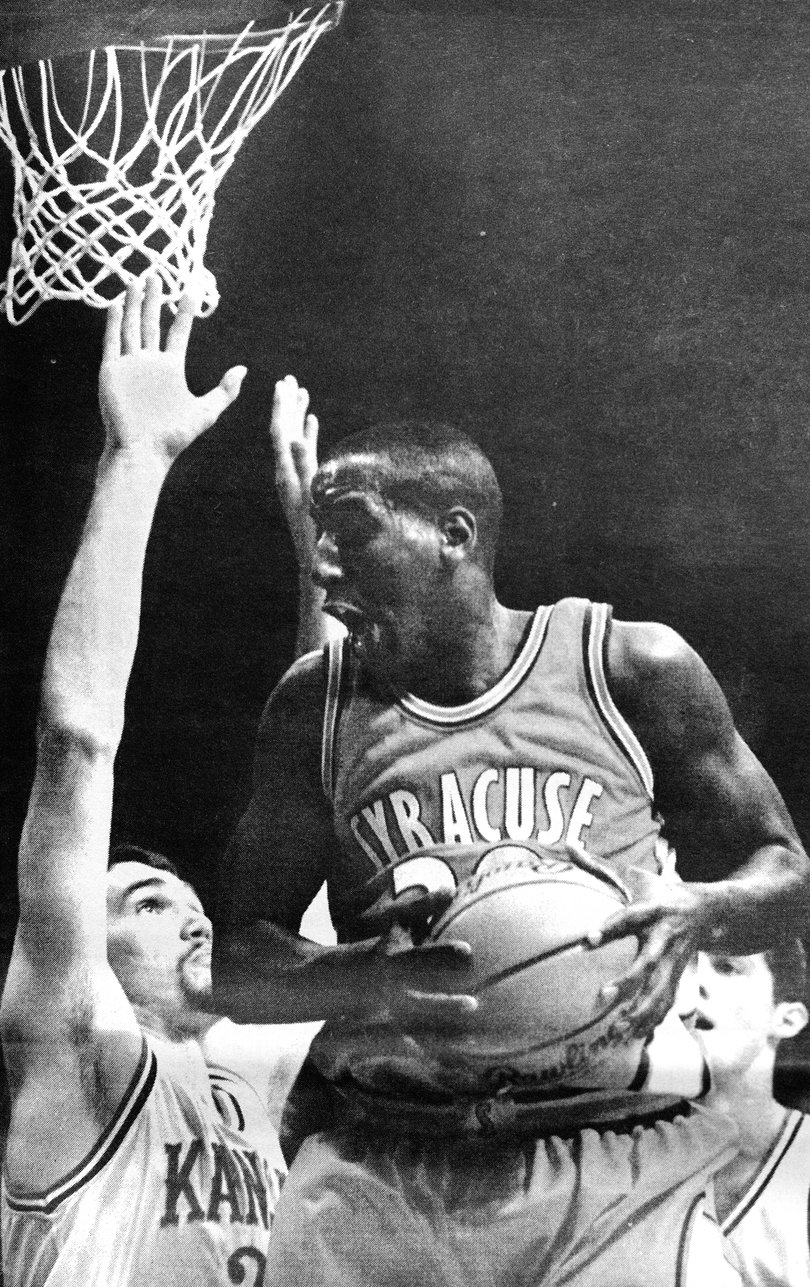 1996: Todd Burgan shoots over Scott Paller and Raef LaFrenz in Syracuse's game against Kansas in the Elite Eight.