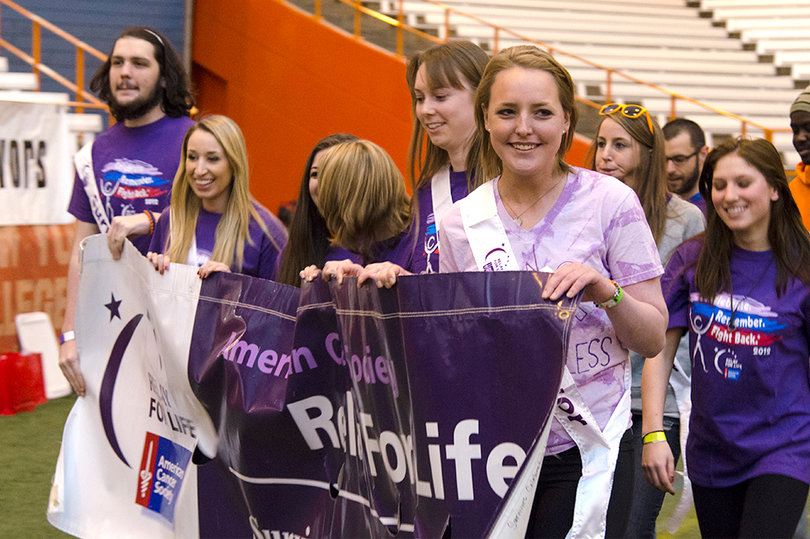 Students advocating awareness for cancer research walk around the Carrier Dome at Relay for Life.