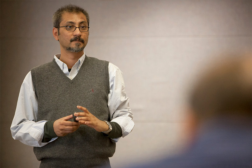 Arnab Basu speaks at Syracuse University on Monday about the buying patterns of coffees labeled "free trade" compared to others.