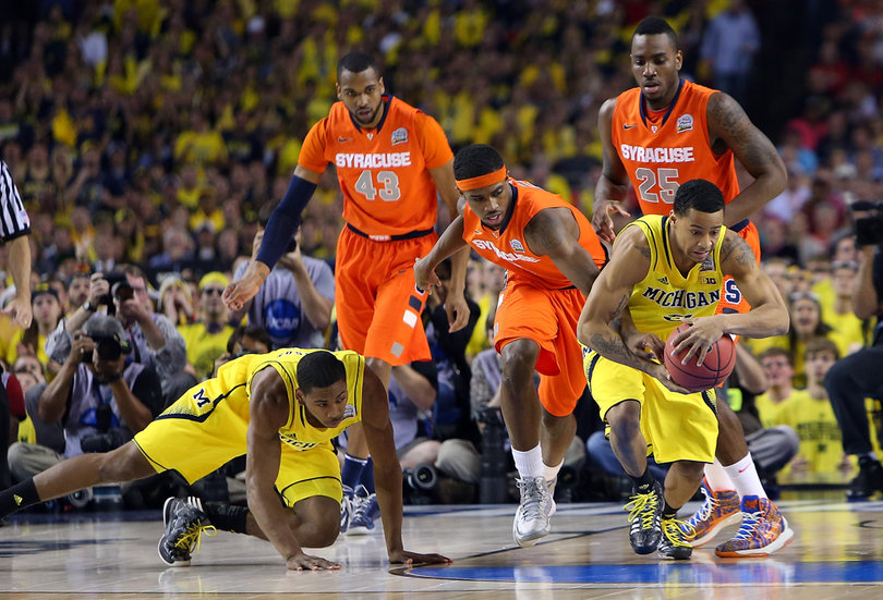 James Southerland #43, C.J. Fair #5 and Rakeem Christmas #25 of the Syracuse Orange reach for the ball against Trey Burke #3 of the Michigan Wolverines.