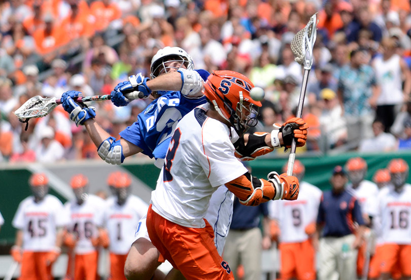 A Syracuse players battles Duke's Brendan Fowler for possession. Fowler won 20-of-28 faceoffs for the Blue Devils.