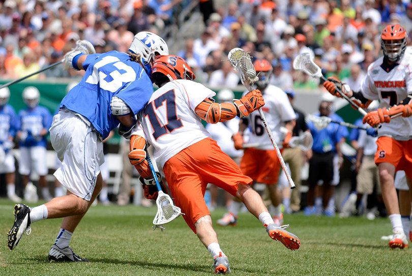 Dylan Donahue shields Duke's Chris Hipps with his left shoulder while dodging. Donahue tallied three goals and one assist.