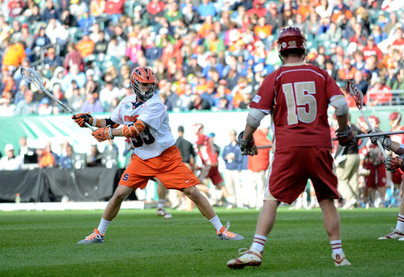 Scott Loy winds up for a shot in front of Denver's Drew Babb.