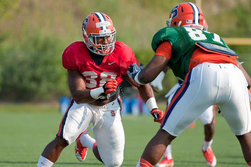 Junior linebacker Cam Lynch tries to rush past freshman offensive lineman Kendall Moore.
