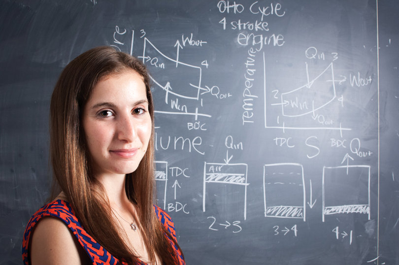 Callie Sher with a drawing of an Otto cycle that explains the fuction of a piston engine.