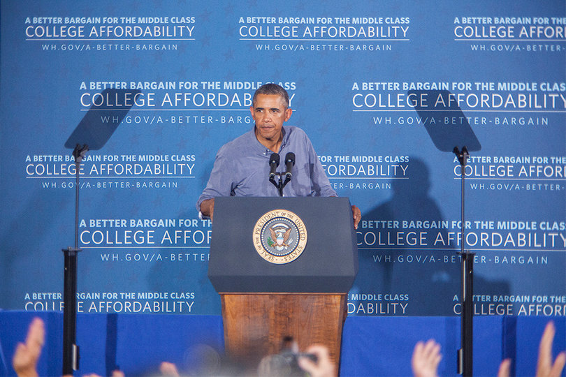 Spectators inside Henninger High School cheer as President Barack Obama leaves the stage. 
