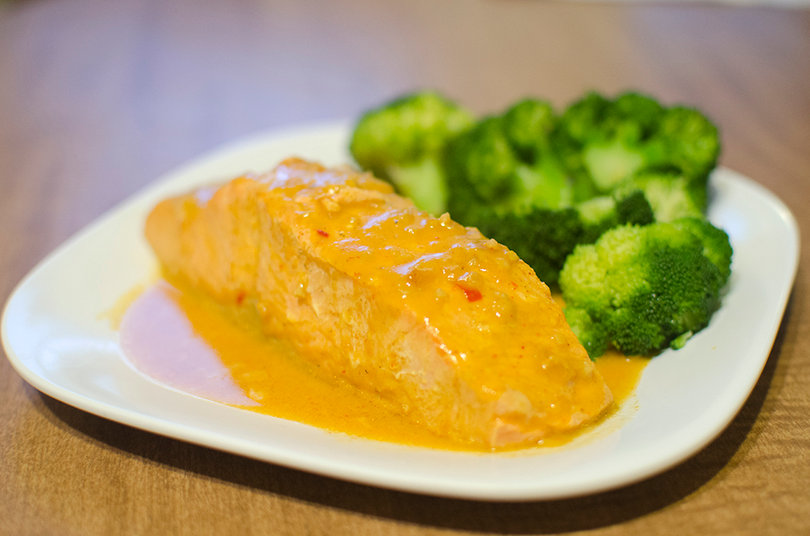 Salmon made with a coconut curry simmering sauce and a side of steamed broccoli is an easy, delicious meal that students can make. 