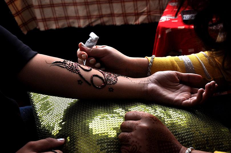 Raychel Renna gets a henna tattoo from Liverpool resident Sally Khawaja at the SK Henna stand during the Westcott Street Cultural Fair. 