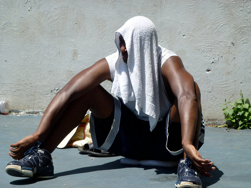 Lewis Bond III drapes a towel over his head as he waits for his next game, following a loss.