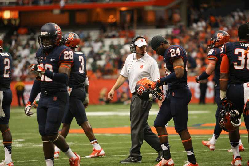 Syracuse head coach Scott Shafer instructs cornerback Jaston George.