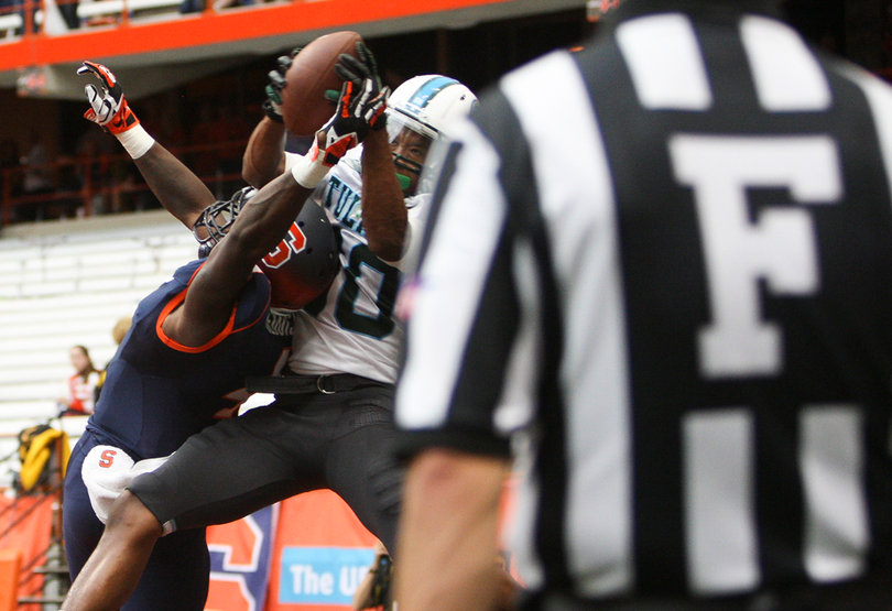 Tulane wide receiver Justyn Shackleford leaps over top the Syracuse defense to haul in a touchdown.