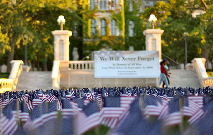 Sept. 9 2013: Almost 12 years after the Sept. 11 terrorist attacks in New York City, Washington, D.C., and Pennsylvania, students at Syracuse University still pay tribute to the lives lost on that day. The College Republicans placed a field of flags on the grass nearby The Remembrance Wall outside of the Hall of Languages. A banner says, "We Will Never Forget" and commemorates the thousands of American lives lost. 