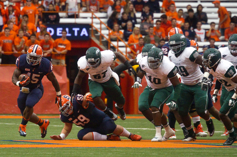With help from center Macky MacPherson, Smith plows forward for a sizable gain. He upped his season touchdown total to five. 