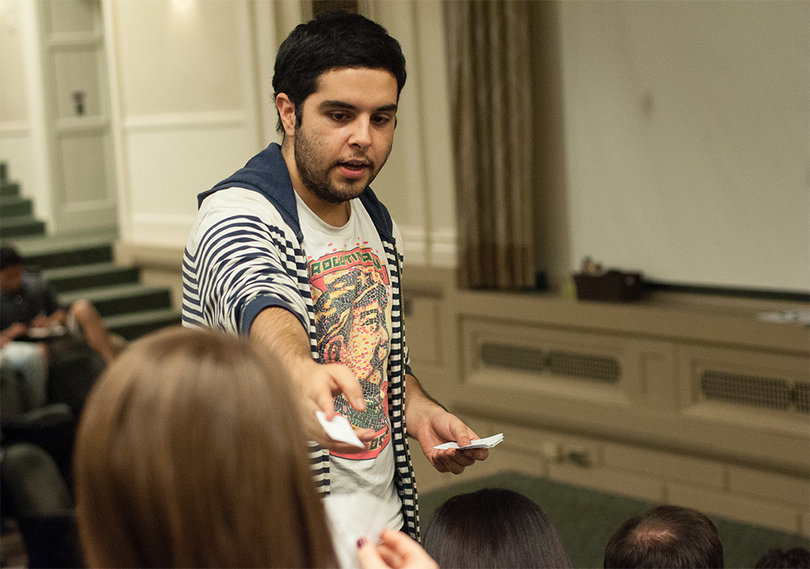 Dan Hernandez, hands out ballots to the Student Assembly members to vote for representatives in the College of Arts and Science. SA elected Richard Ofosuhene, a sophomore chemistry major and Henry Hokura, a freshman international relations major.