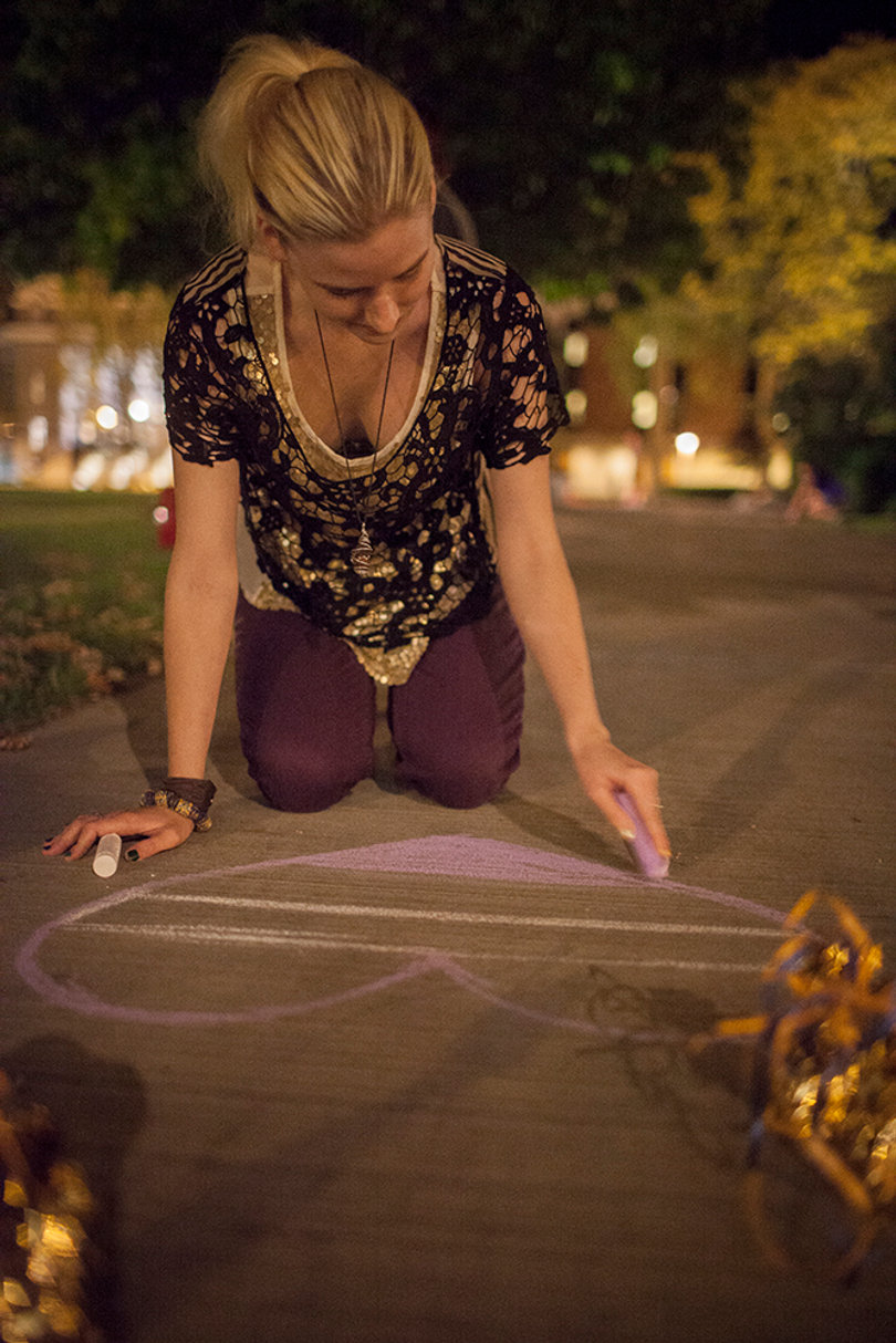 Midge Scully, a junior illustration major, attends Chalk the Quad Wednesday evening. Scully, who identifies as asexual, was one of the students who shared coming out stories. 