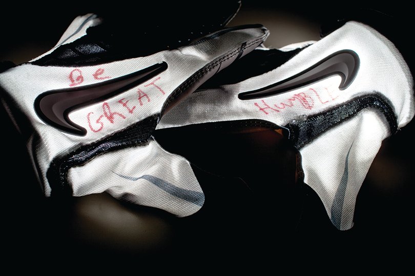 Oct. 9, 2013: Thin red letters are written across the back of Jay Bromley’s gray and white practice gloves. The gloves serve as a reminder to Bromley about where he came from and who got him there.