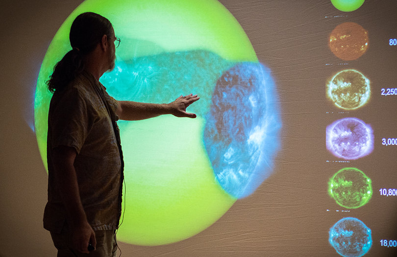 Lorne Covington, a response environment digital artist, shows off one of his recent works. It is an interactive hover-and-touch model of the “unseen sun” that allows users to “hover” through images of the sun and examine its different temperature ranges.