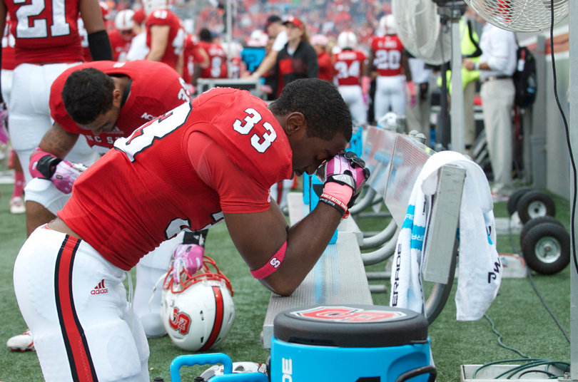 Linebacker Roderick Cox rests by a cooler full of Gatorade. 