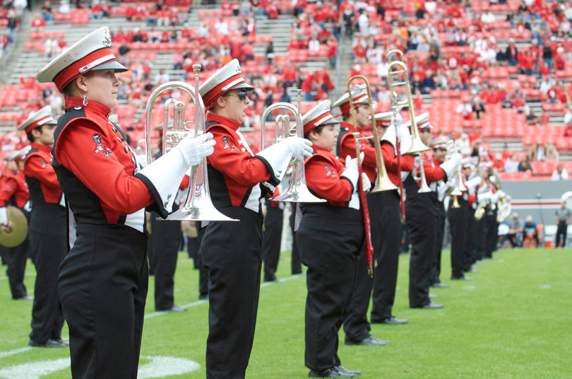 The North Carolina State marching band plays in front of a crowd of 48,961.