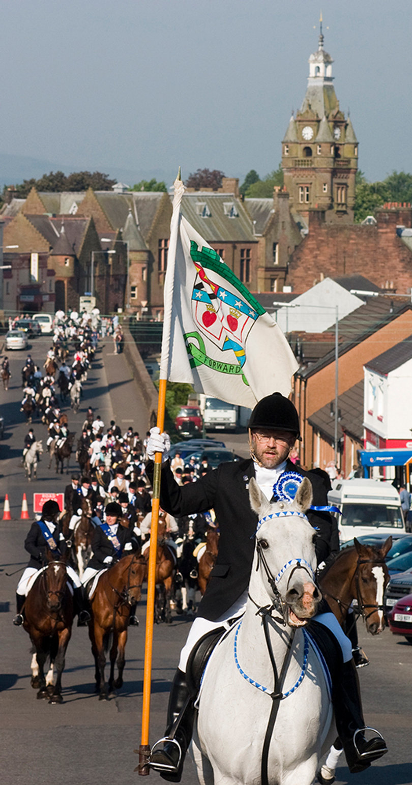 Tim Liddon, carries the town’s flag as he leads the Riding of the Marches on Gala Day. He is the father of two former Lockerbie Scholars.