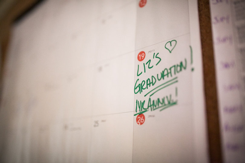 A calendar hanging inside the kitchen of the Exodus House marks Garcia’s graduation celebration.