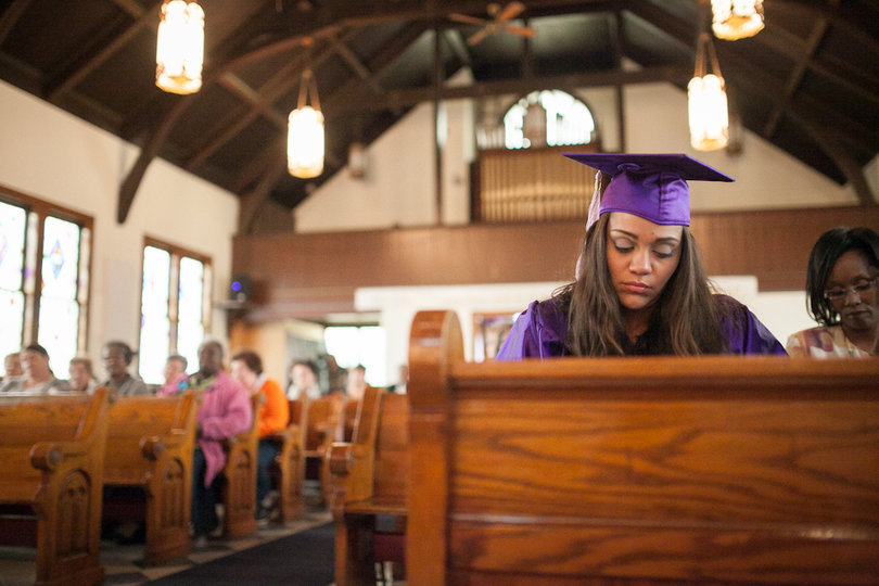 Liz Garcia sits in a pew, waiting to give her graduation speech inside St. John’s Church.