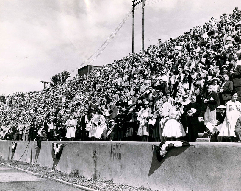 A crowd of about five thousand people, including 1,627 degree candidates in Syracuse University's class of 1957, fill Archbold Stadium during graduation.