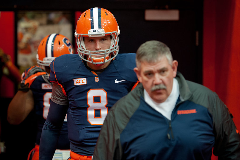 Backup quarterback Drew Allen follows Syracuse assistant Will Hicks onto the field. 