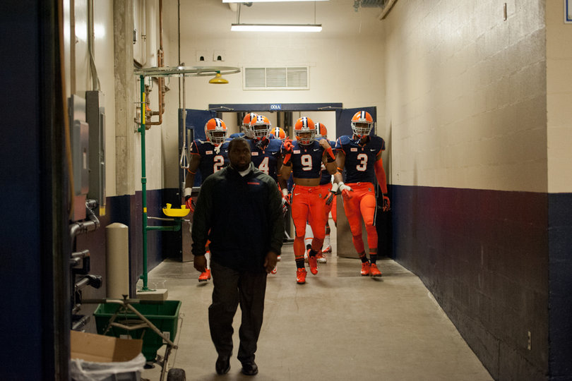 Syracuse's secondary walks shoulder-to-shoulder through the tunnel en route to the Carrier Dome field. 