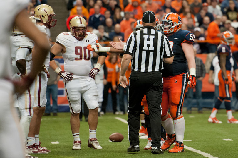 Syracuse center Macky MacPherson chats with the referee in between snaps. 