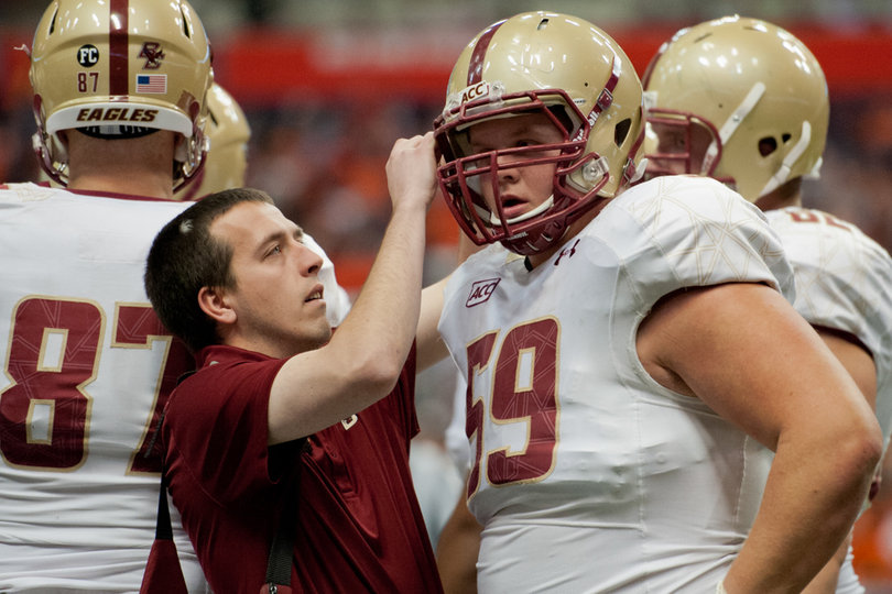 Boston College center Andy Gallik receives attention for his helmet during a timeout. 